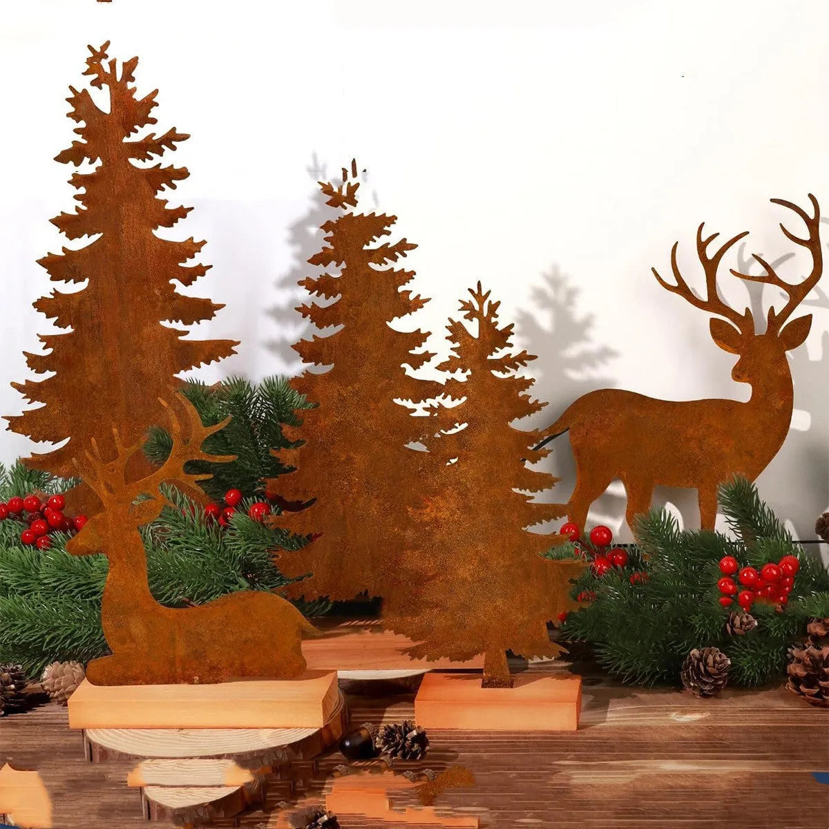 Set of three rustic metal Christmas ornaments featuring elk and tree silhouettes with an aged iron finish.