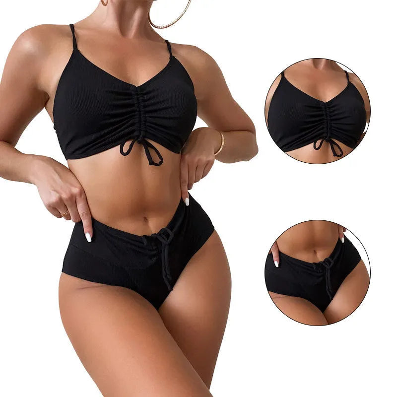 Black women's bikini swimsuit with sling top and high-waisted shorts on a white background