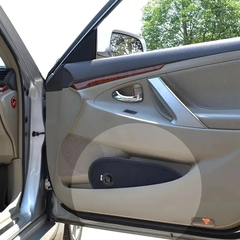 Black stretchy car side window sunshade for babies attached with suction cups, shown in a compact stored size