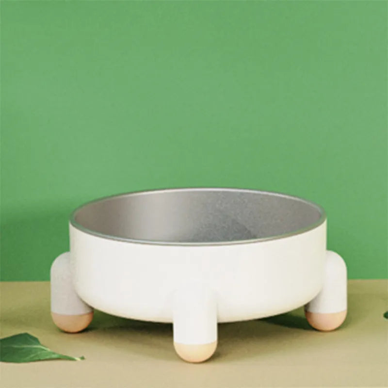 Green stainless steel pet bowl with high foot and non-slip base on a floor