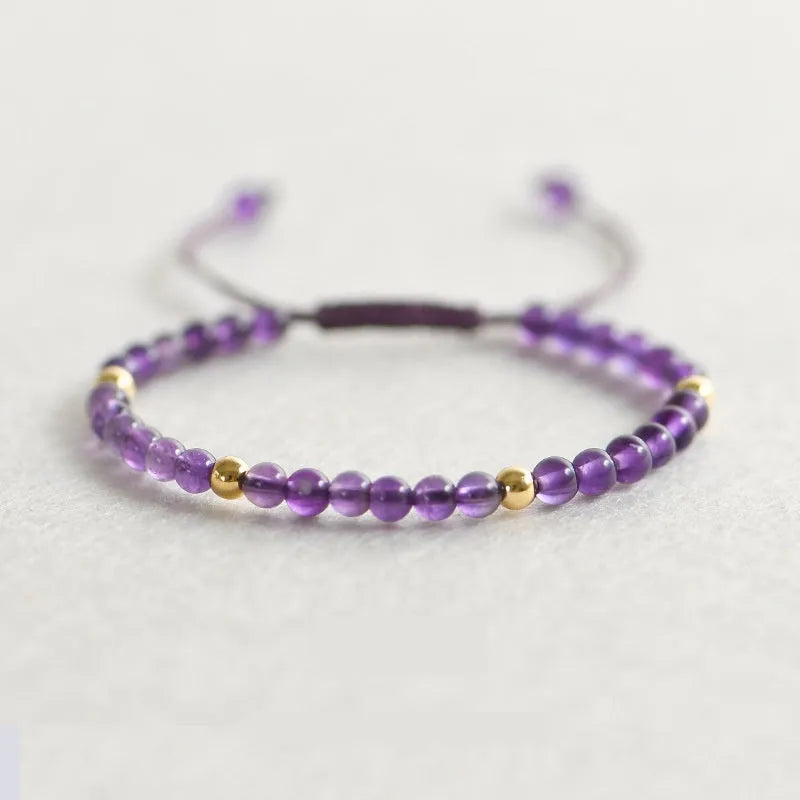 Women's freshwater pearl bracelet with crystal accents and geometric charms on elastic rope