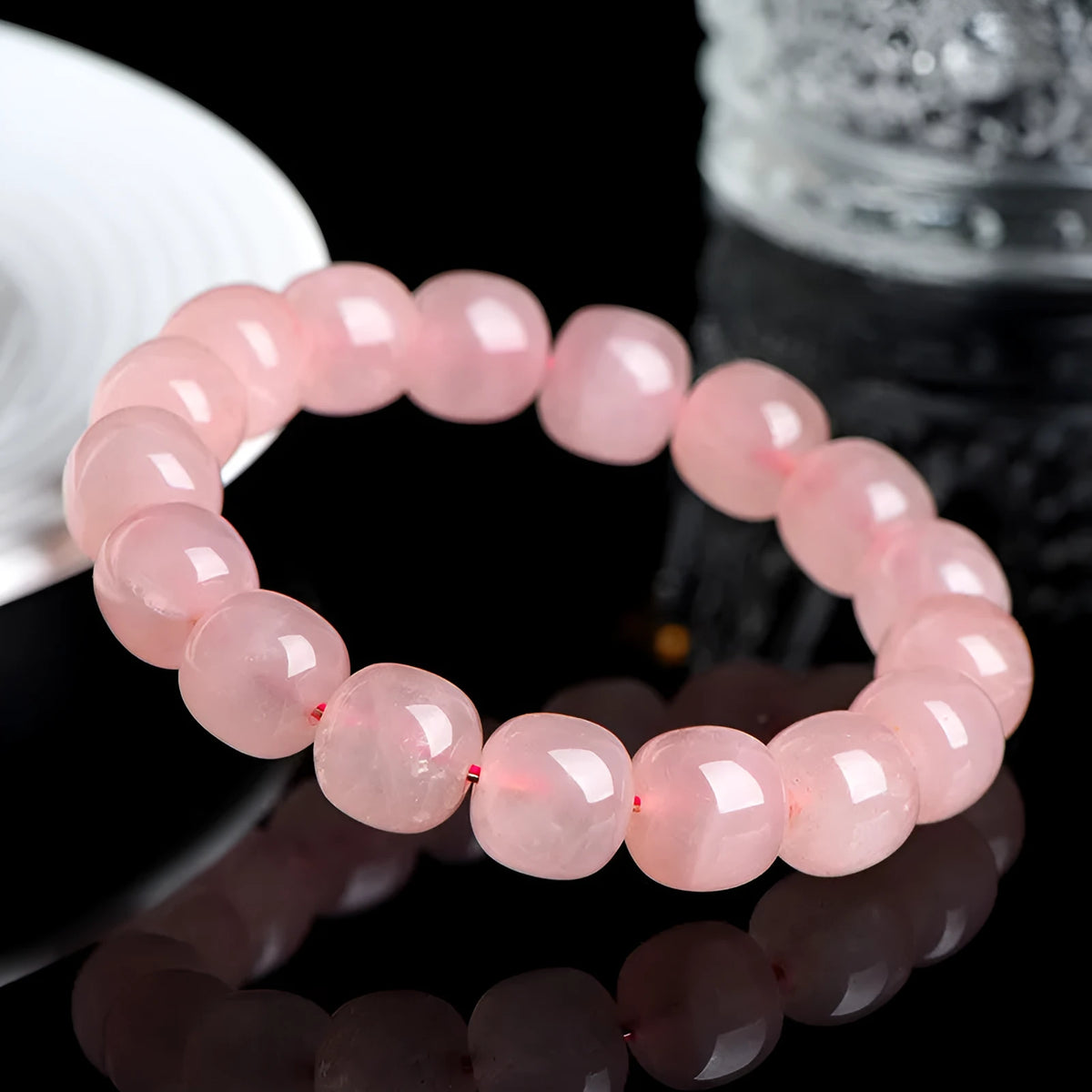 Natural pink crystal barrel bead bracelet with geometric design, 8-10mm beads