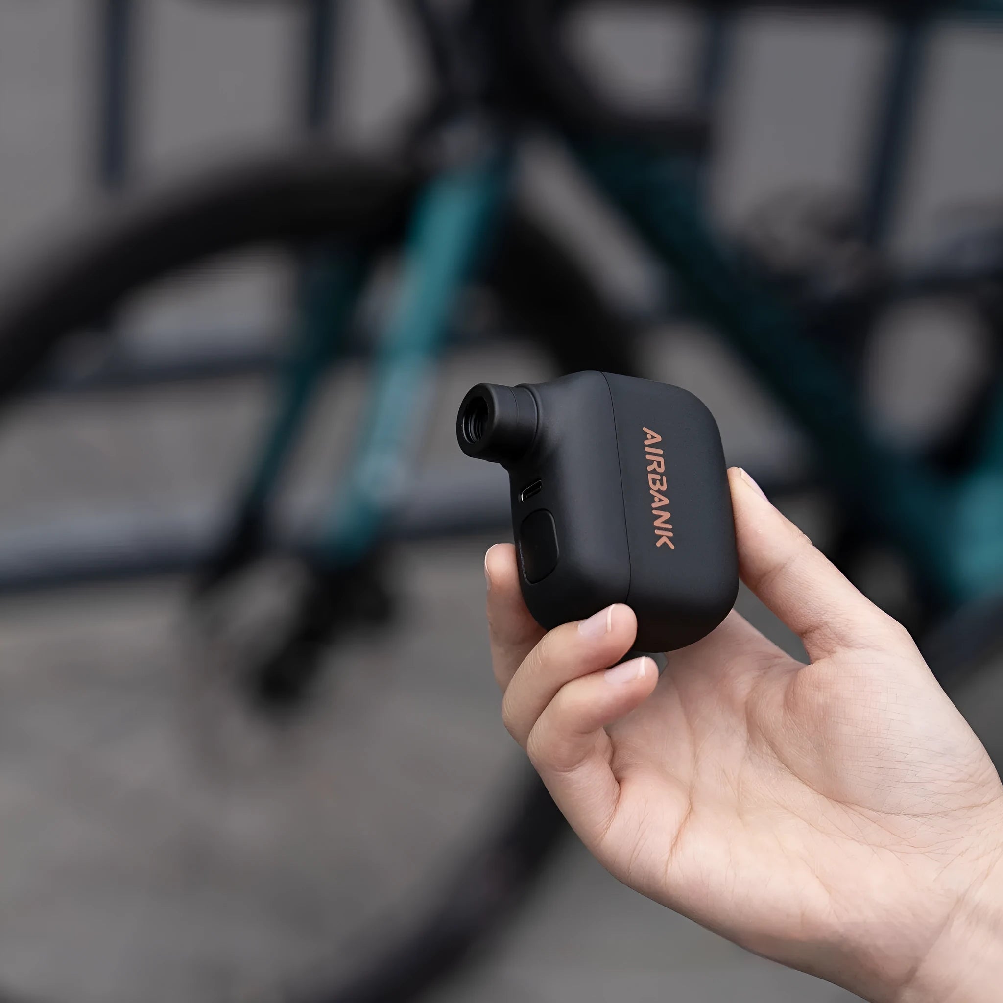 Black mini electric bicycle pump with USB charging port and compact dimensions