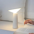 Black USB rechargeable LED desk lamp with touch controls and an adjustable lamp head on a wooden desk