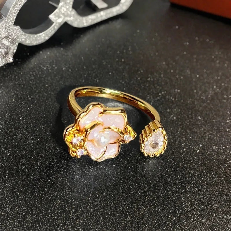Adjustable copper ring with vintage oil dripping finish showing gourd, flower and bow design with inlaid zircon stones.