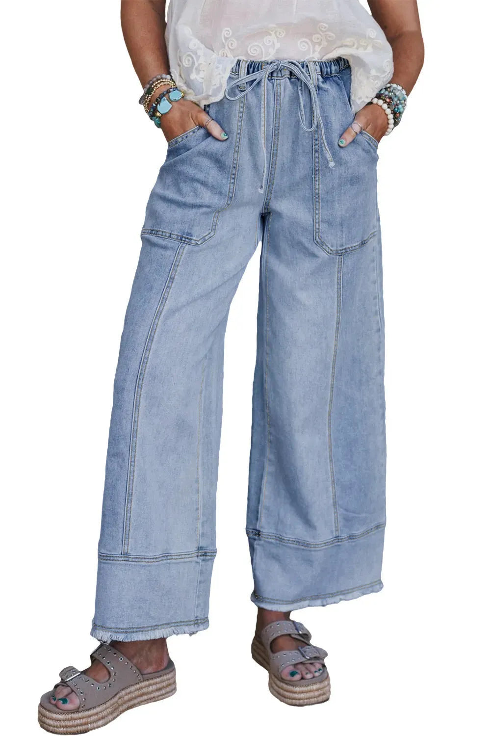 Beau blue women's wide-leg denim trousers with a drawstring waist and raw hem detail laid flat.