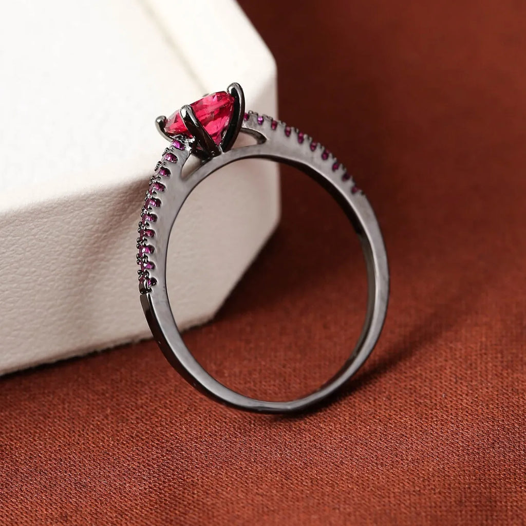 Copper hexagon geometric ring in electroplated gold rose red colour on a size 8 finger.
