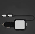 Black and gold dual USB car charger with retractable cable plugged into a car dashboard