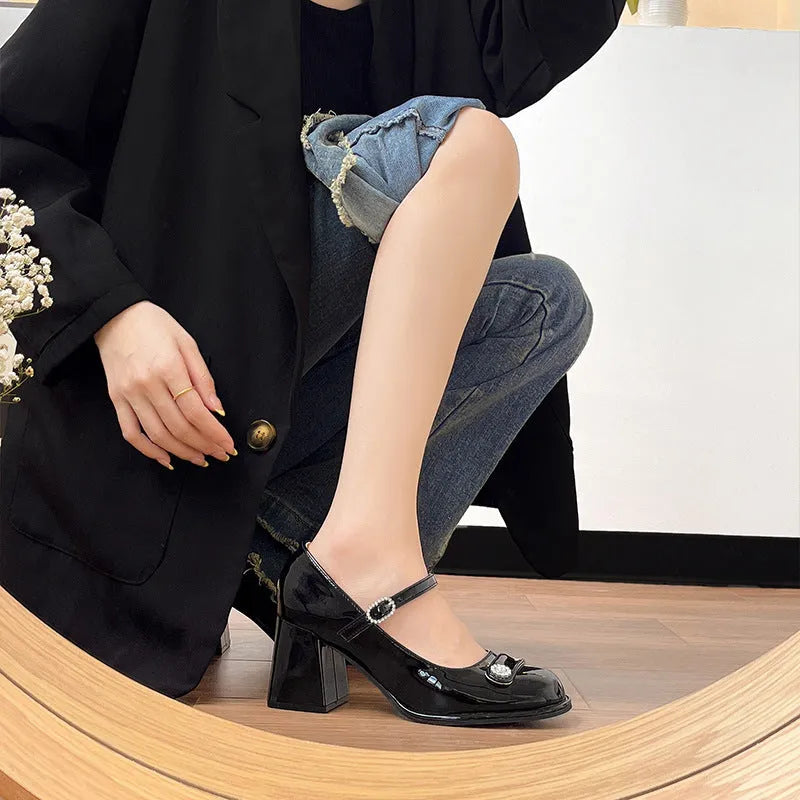 Black patent leather women's chunky heel shoes with round toe and buckle fastening for wide feet