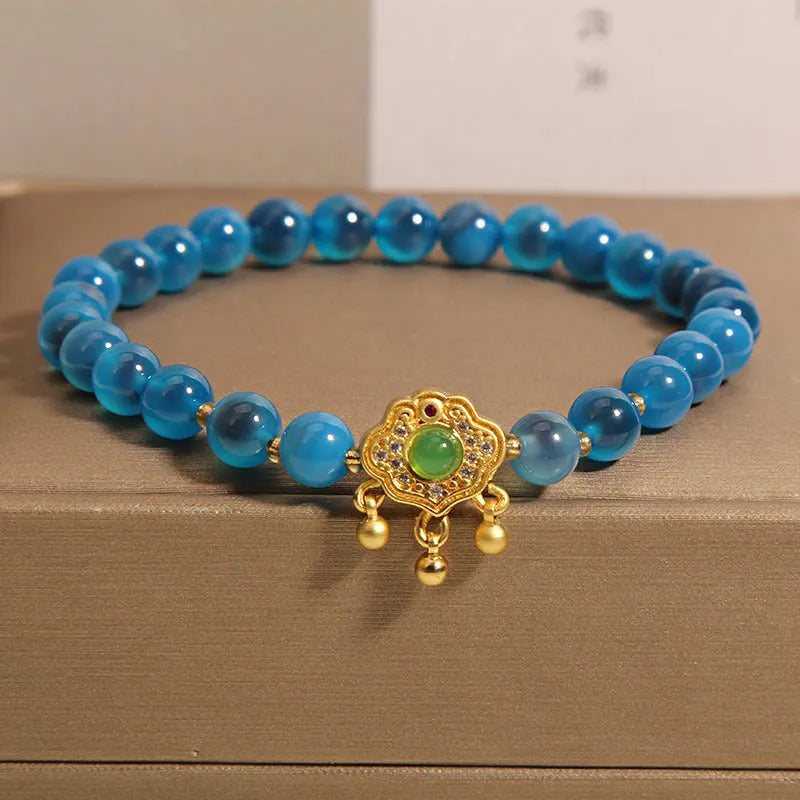 Blue sugar heart agate safety lock pendant on a crystal women's bracelet with alloy inlay and rhinestones.