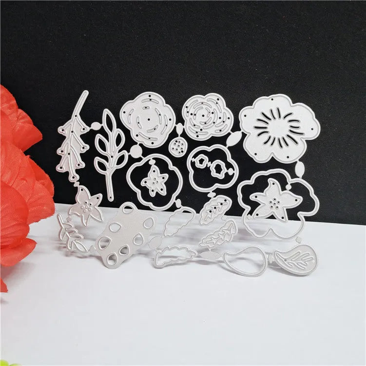 Silver carbon steel paper cutting die with floral plant design measuring 14.3 by 9.9 cm