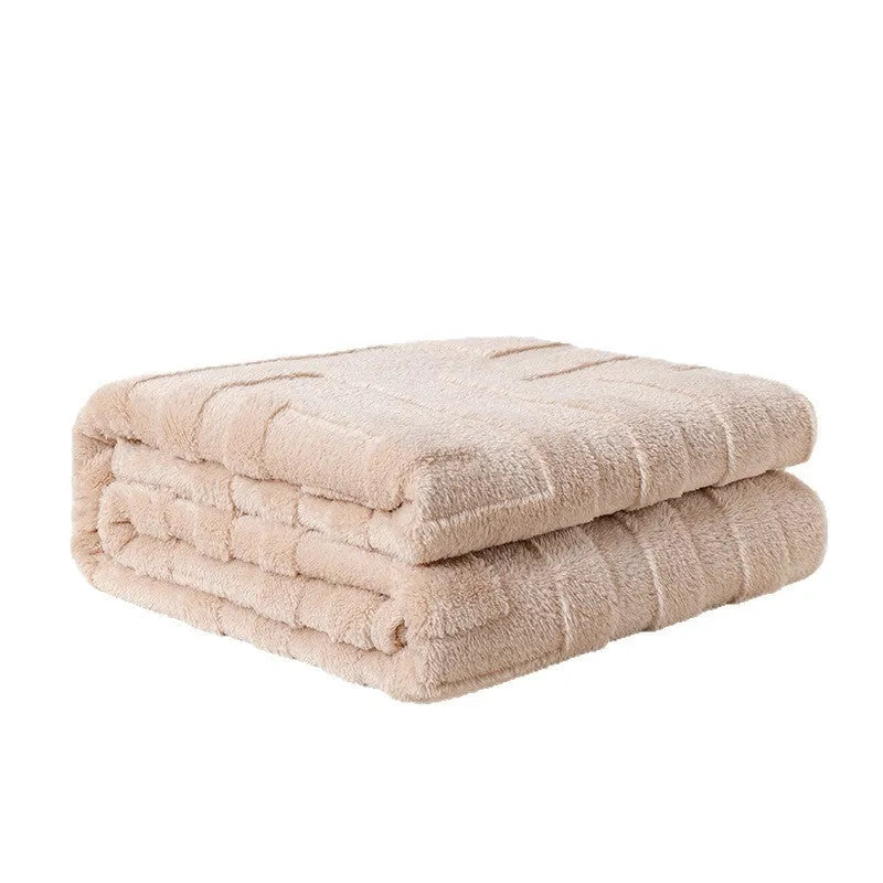 Brown coral fleece sofa throw blanket draped over a grey sofa.