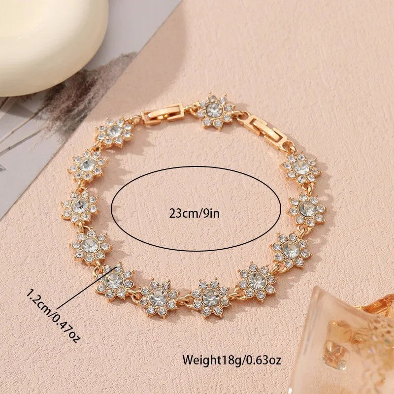 Gold and silver electroplated flower bracelets with coloured gems and crystals on a zinc alloy base.