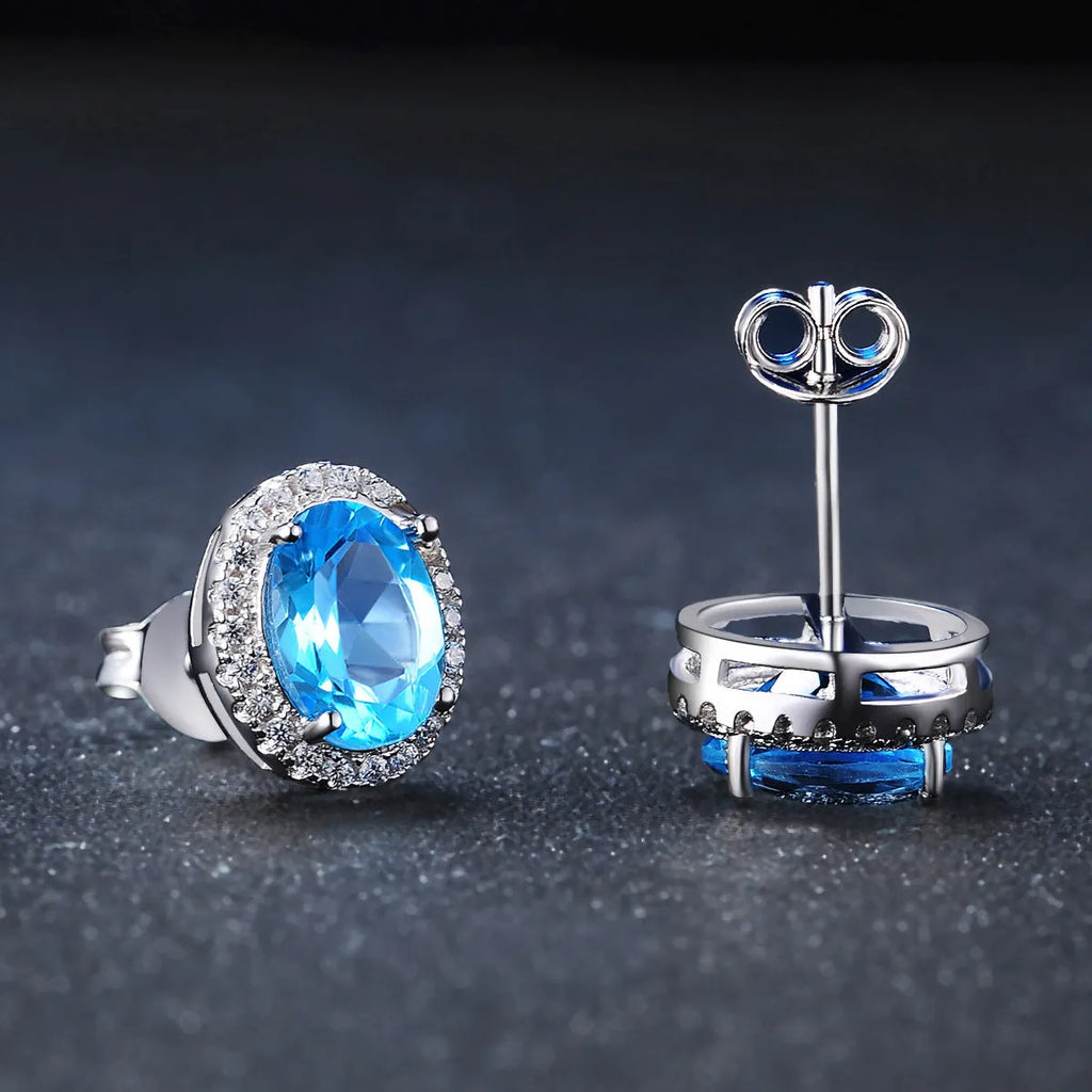 925 sterling silver geometric jewellery set with blue topaz gemstones including earrings, ring, pendant and necklace