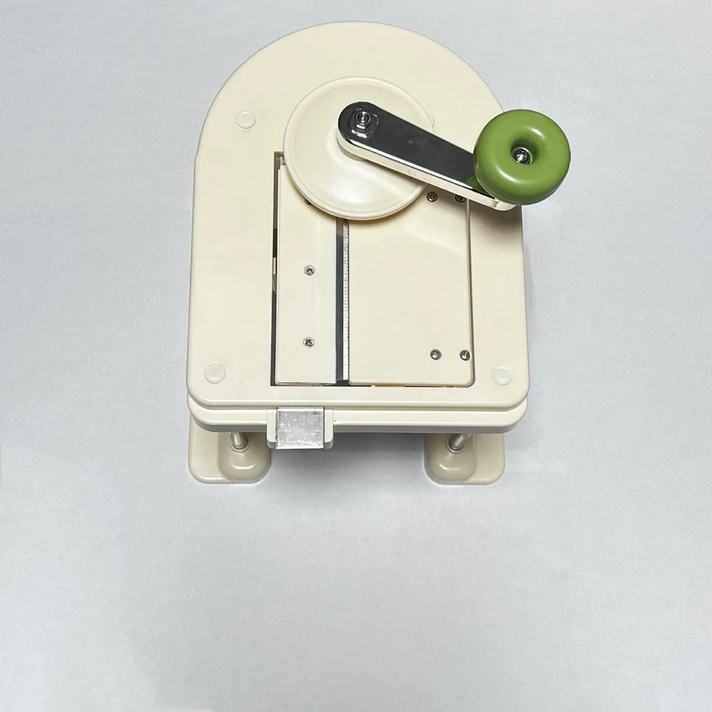 Beige stainless steel vegetable slicer chopper grater with spiralizer function on kitchen counter