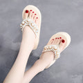 Women's black cotton high-heeled flip-flop sandals showing elevated sole and cloth upper