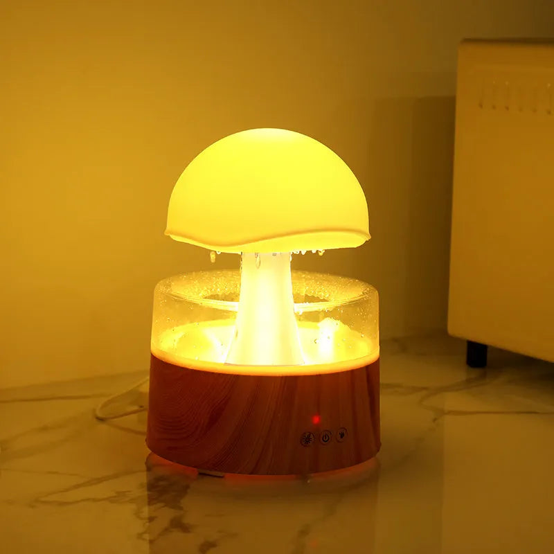 White cloud-shaped humidifier and aroma diffuser with coloured lights and simulated raindrops