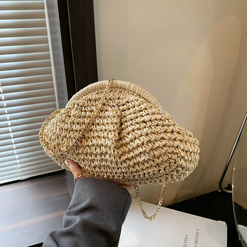 Women's shell-shaped straw shoulder bag with chain strap in khaki colour showing zippered internal pocket