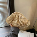 Women's shell-shaped straw shoulder bag with chain strap in khaki colour showing zippered internal pocket
