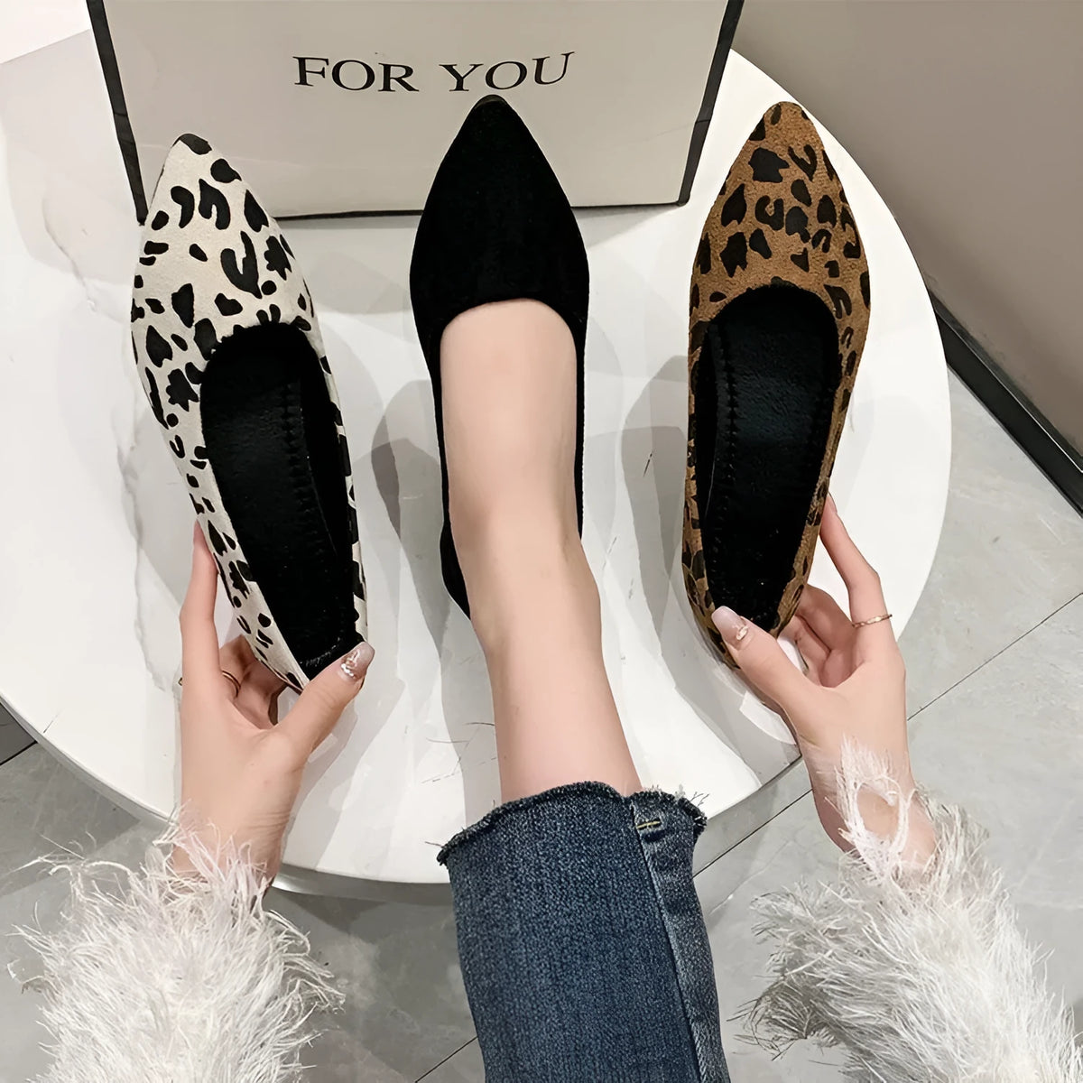 Women's leopard print flat pumps with a pointed toe and low flat heel on a rubber sole.