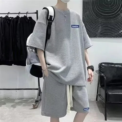 Waffle texture leisure sports suit set consisting of a short sleeve top and shorts, shown in blue.