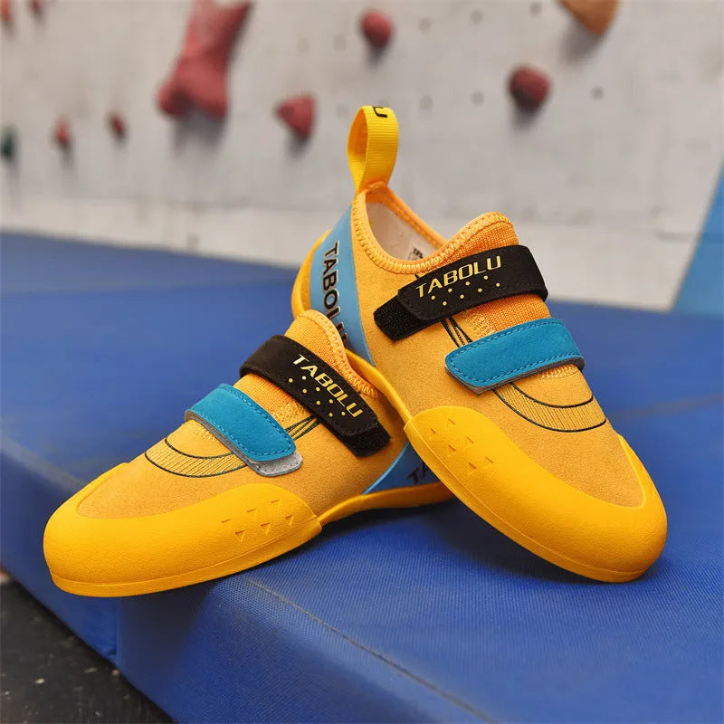 Beginner unisex rock climbing shoes with black and red colourway, showing Velcro strap and rubber sole.