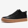 Men's black leather casual shoes with round toe and flat rubber sole on white background