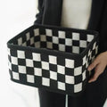 Checkerboard patterned foldable felt storage basket showing its box shape and textured sides.