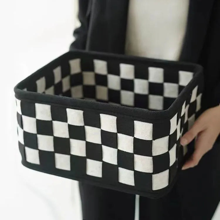 Checkerboard patterned foldable felt storage basket showing its box shape and textured sides.