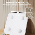 White professional body fat scale with eight electrodes and LED display on tempered glass platform