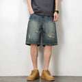 Man wearing blue retro-style loose denim shorts with a straight leg cut.