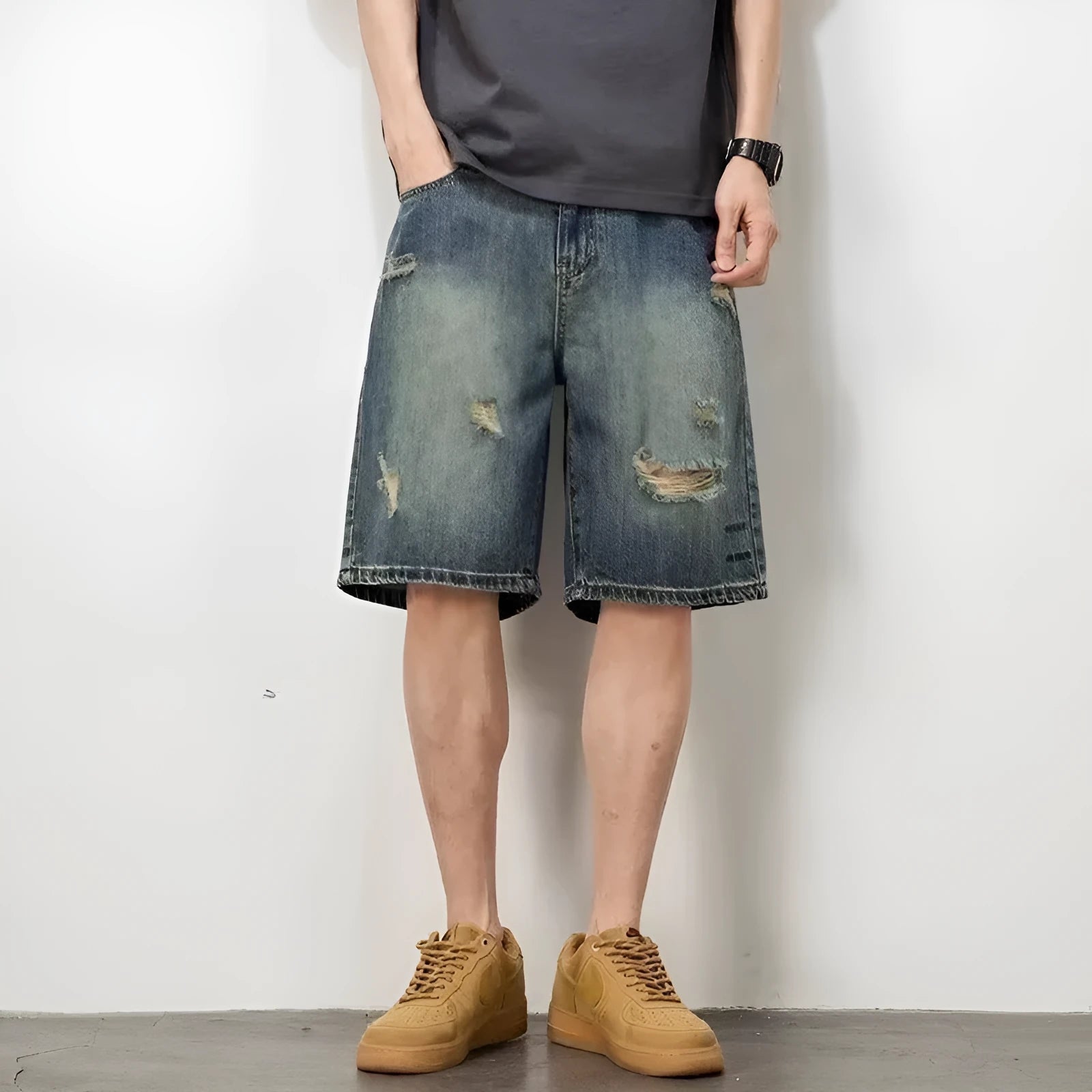 Man wearing blue retro-style loose denim shorts with a straight leg cut.