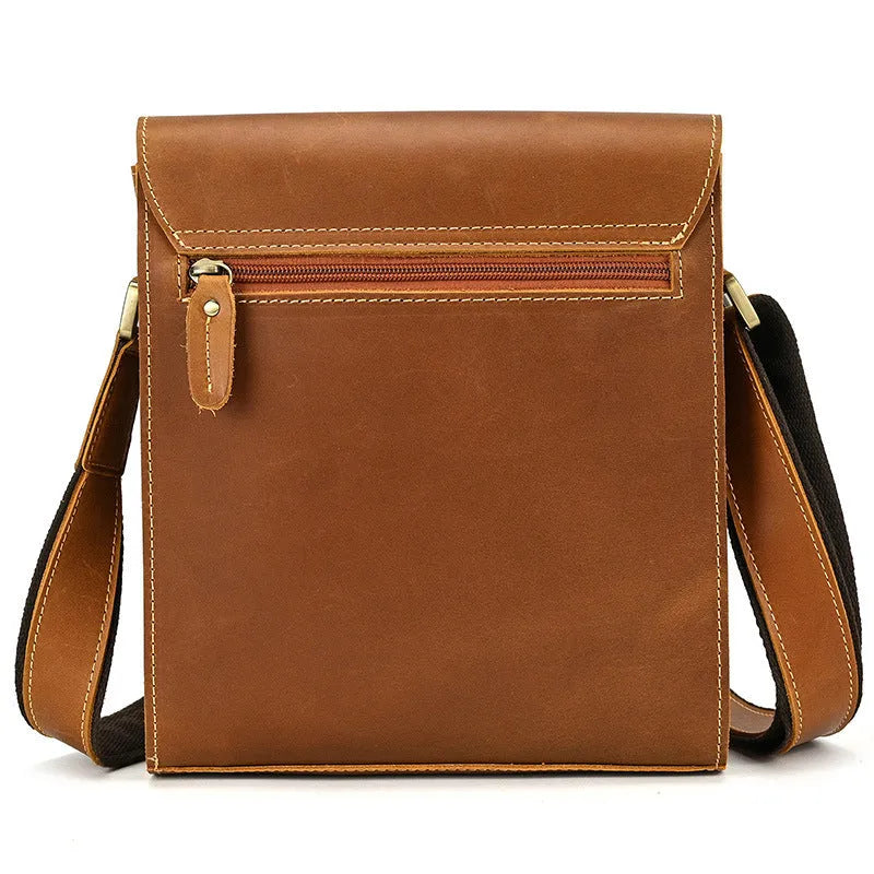 Dark brown cowhide leather crossbody shoulder bag for men on a table.