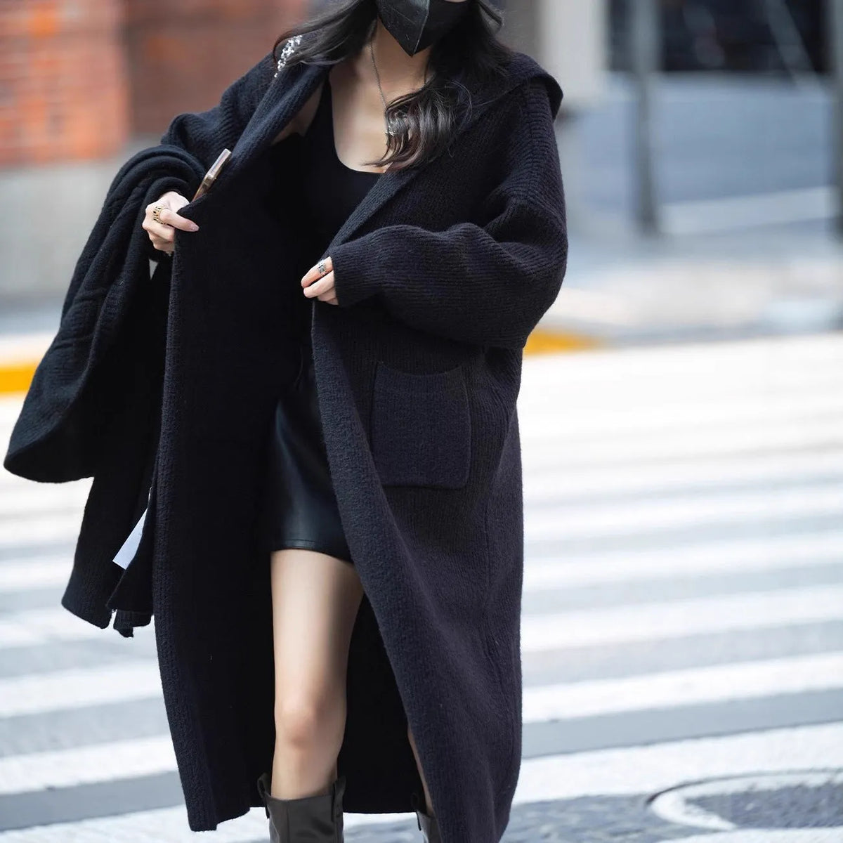 Long grey knitted hooded cardigan with trench coat styling on hanger