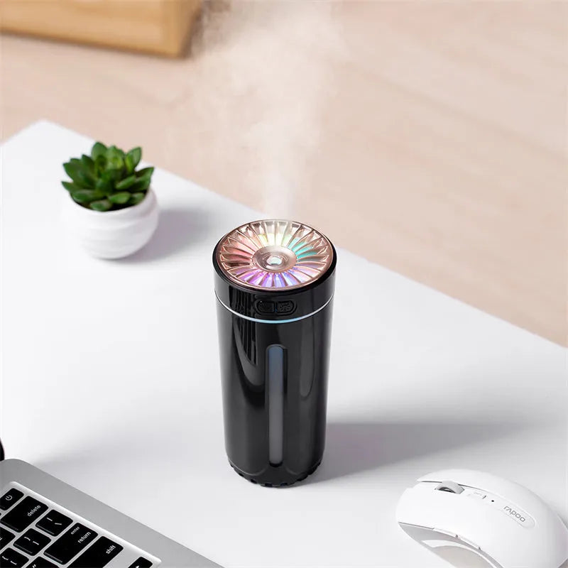 Black USB rechargeable ultrasonic humidifier with LED lights on a car cup holder