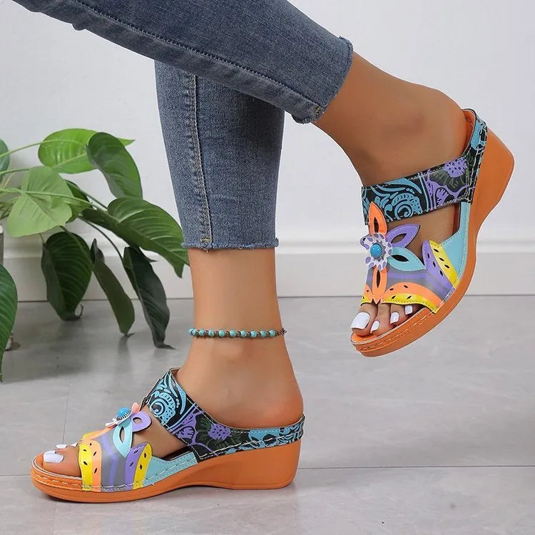 Women's ethnic patterned slope heel slippers in purple with a round toe and rubber sole.
