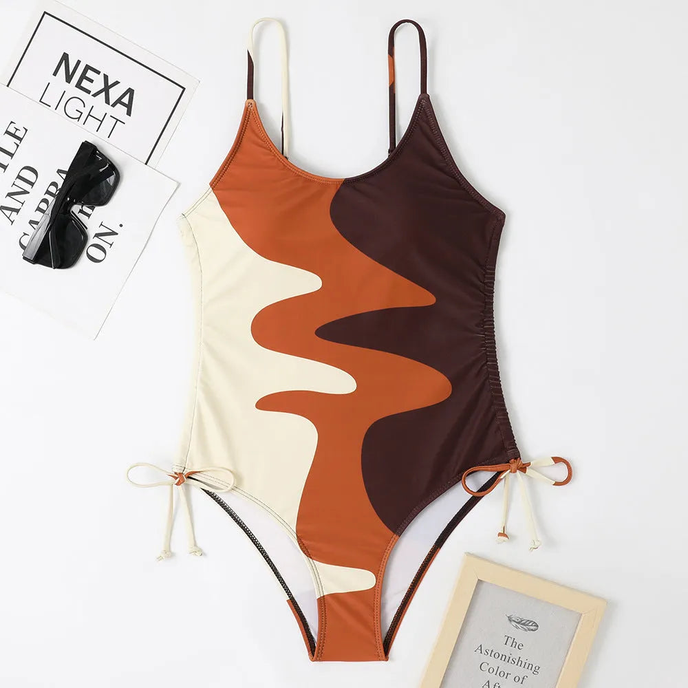 Women's sleeveless backless one-piece swimsuit in blue, purple, brown, or green with solid or striped pattern