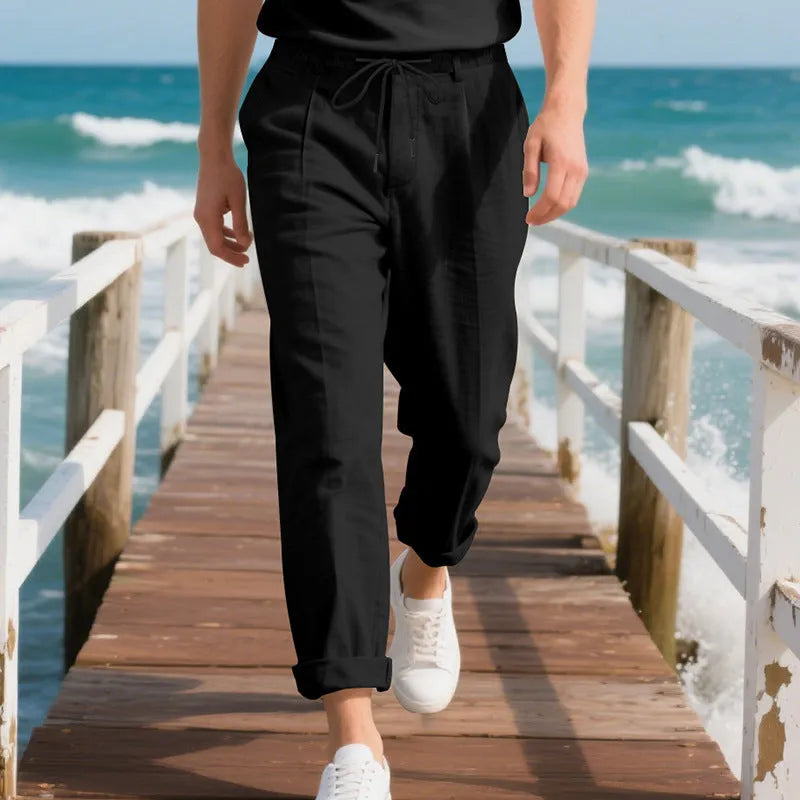 Men's light khaki linen casual trousers with a drawstring waist and straight leg fit.