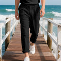 Men's light khaki linen casual trousers with a drawstring waist and straight leg fit.