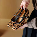 Women's black square toe stiletto heel ankle-strap shoes with a horse hair upper.
