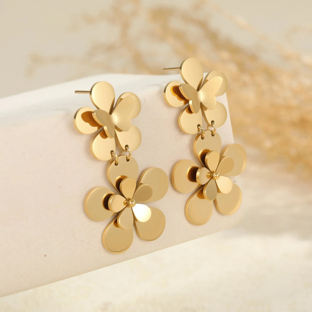 Gold coloured flower butterfly earrings with geometric and zodiac details on stainless steel.