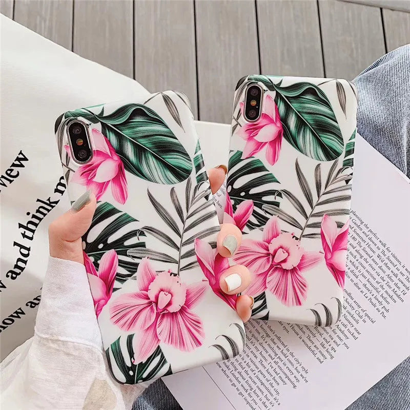 Pink floral pattern TPU back cover case for iPhone on a wooden table.