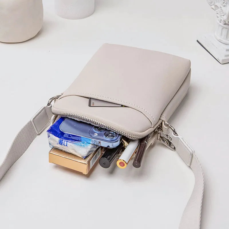 Solid colour PU leather mobile phone crossbody bag in beige showing shoulder strap and compact size