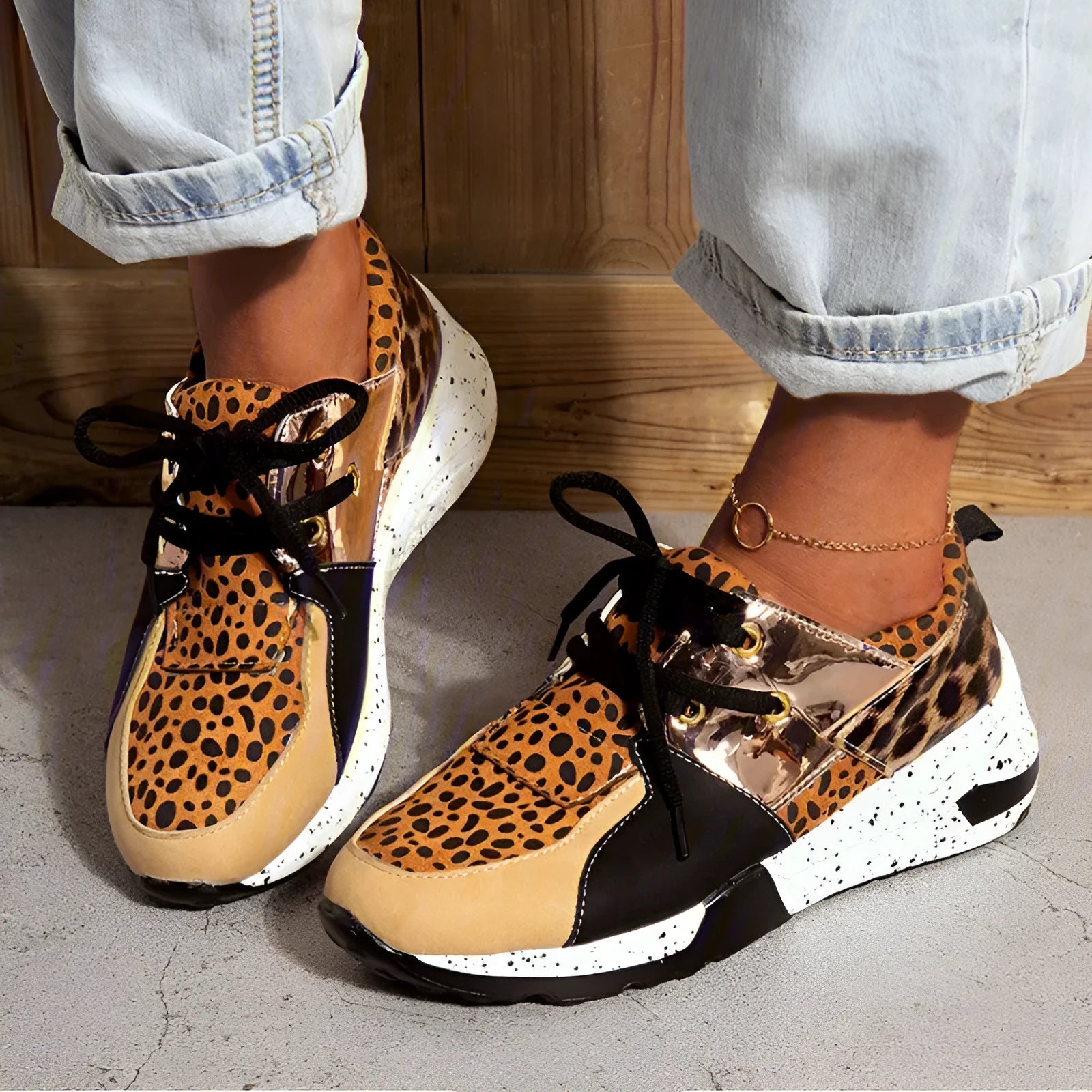 Women's black casual sneakers with a suede upper and a low wedge heel on a plastic sole.