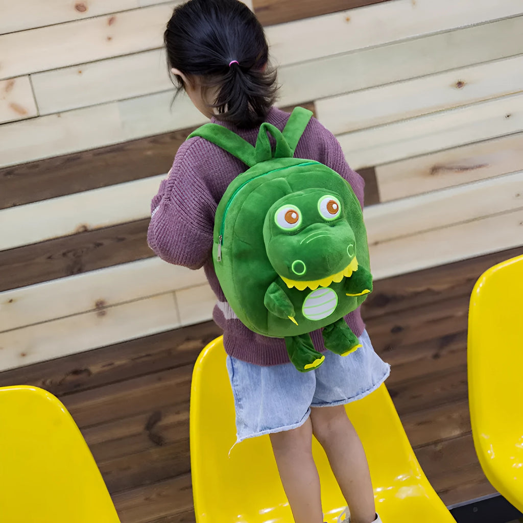 Blue baby dinosaur plush backpack with embroidery, soft handle, and a childlike cute style.