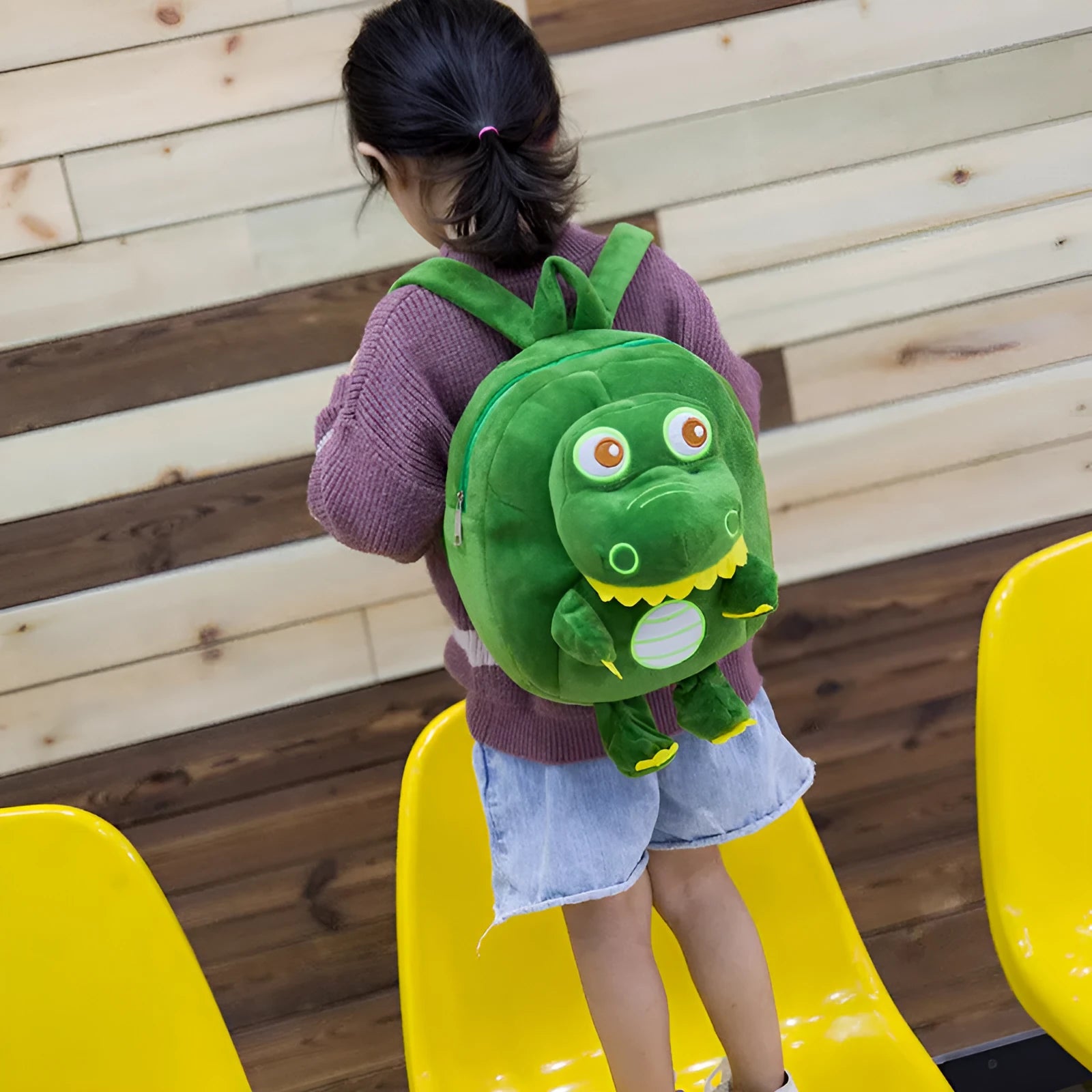 Blue baby dinosaur plush backpack with embroidery, soft handle, and a childlike cute style.