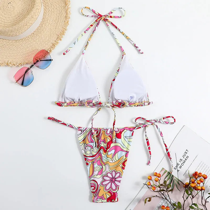 Multicolor printed women's triangle bikini top with hanging neck and matching bottoms.