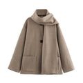 Women's long grey polyester overcoat with artificial fur collar and pockets, styled in street fashion.