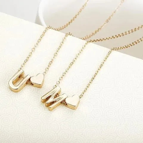 Peach heart shaped letter necklace pendant in gold and silver alloy tones weighing 5.5g
