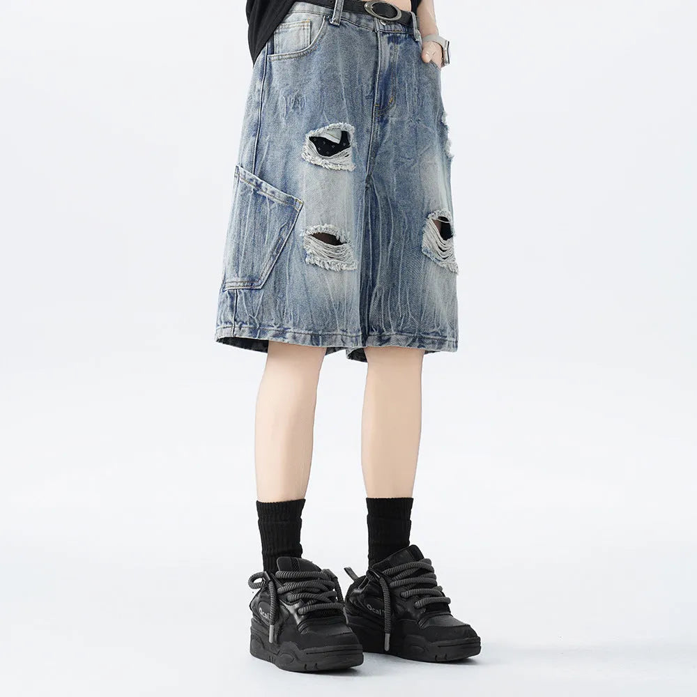 Black and Blue ripped denim shorts with a washed vintage finish and loose, retro fit.